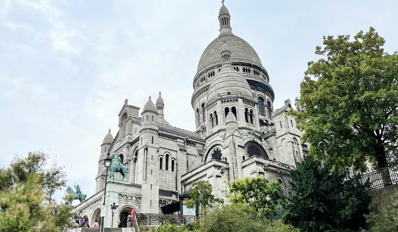A view of the domed stone Sacré-Coeur Basilica in Montmartre, a neighborhood in Paris, France