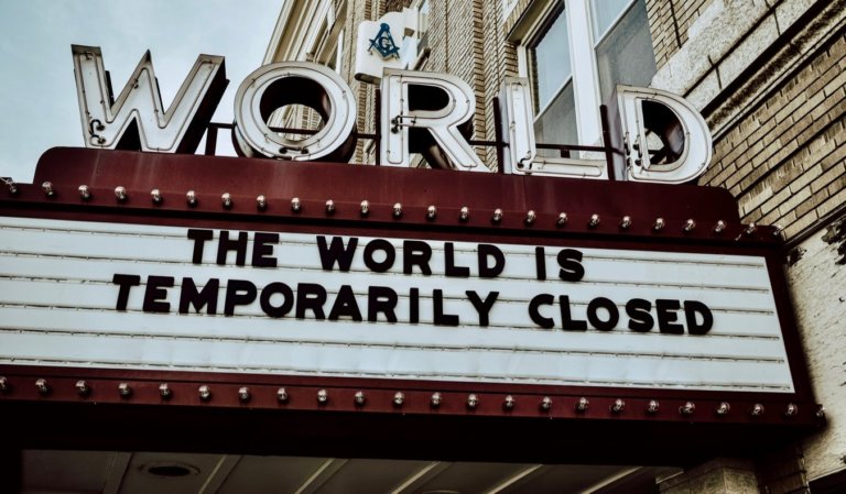 A movie theater billboard saying the world is closed