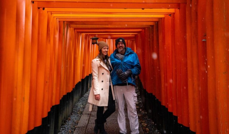 Blogger Kristin Addis of Be My Travel Muse with her partner and baby at Fushimi Inari Shrine in Japan