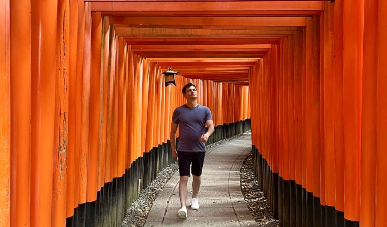 Nomadic Matt walking through the famous torii gates in beautiful Japan