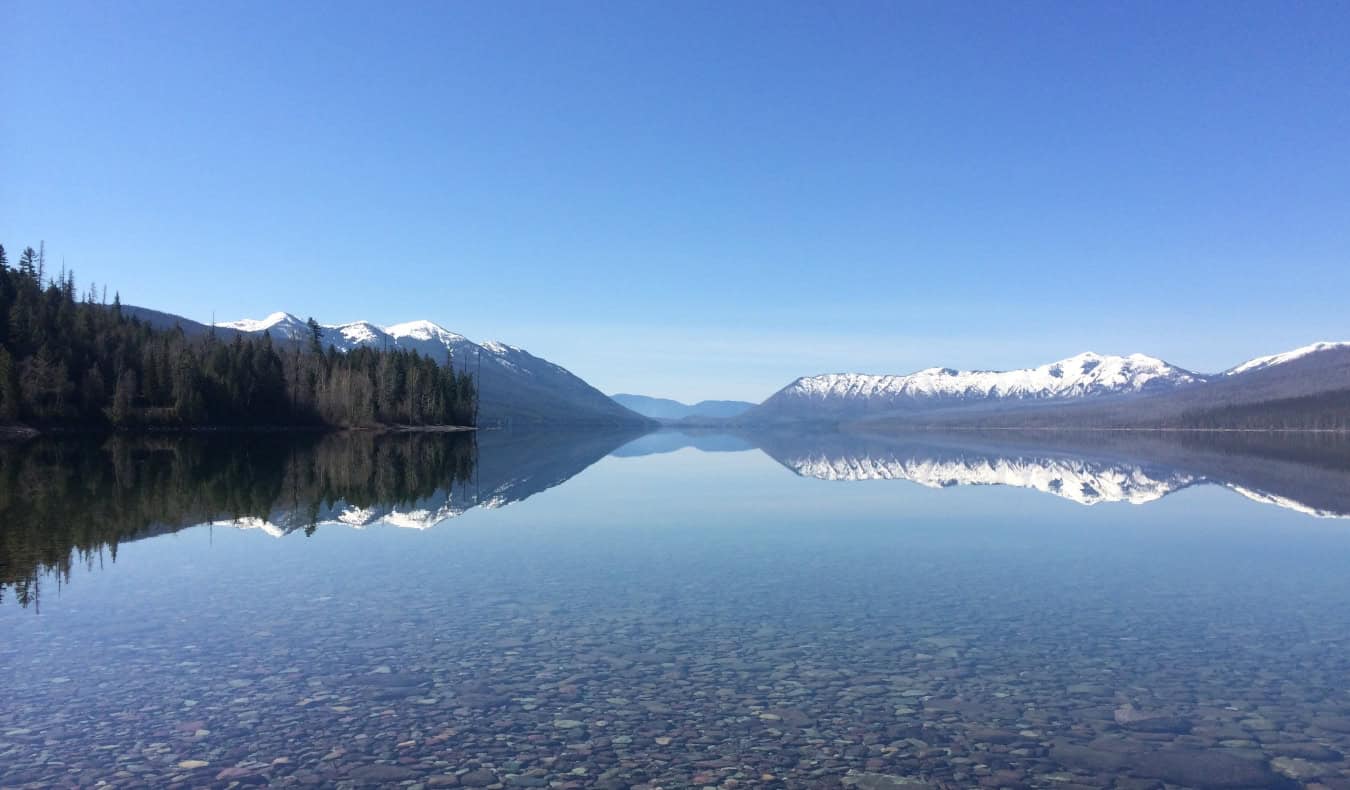 A crystal clear lake lined with mountains in Montana, USA
