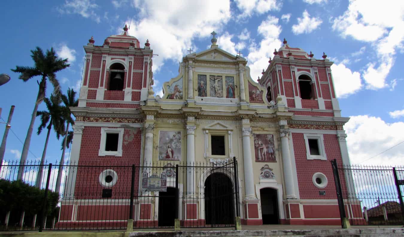 A tall and historic building on a sunny day in Leon, Nicaragua