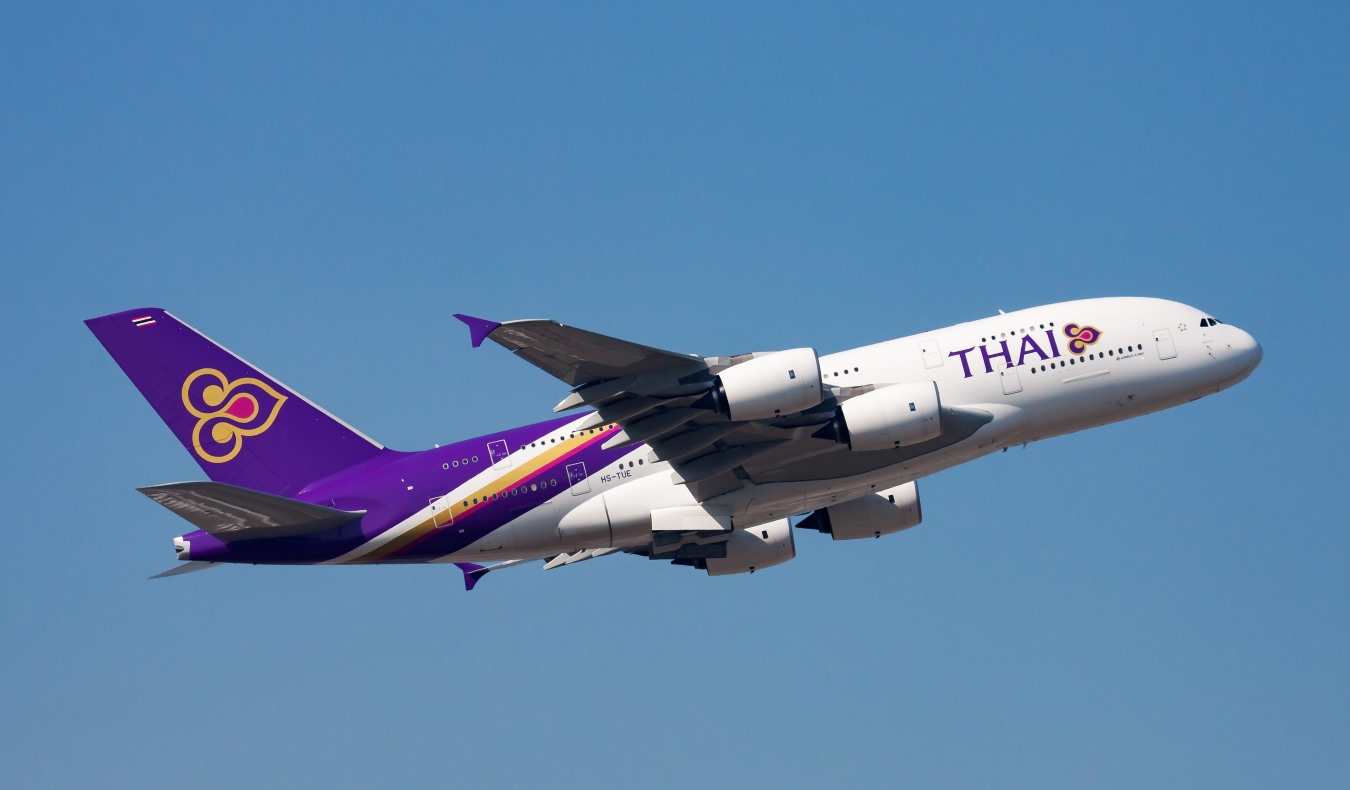 a Thai Airways plane taking off in Thailand