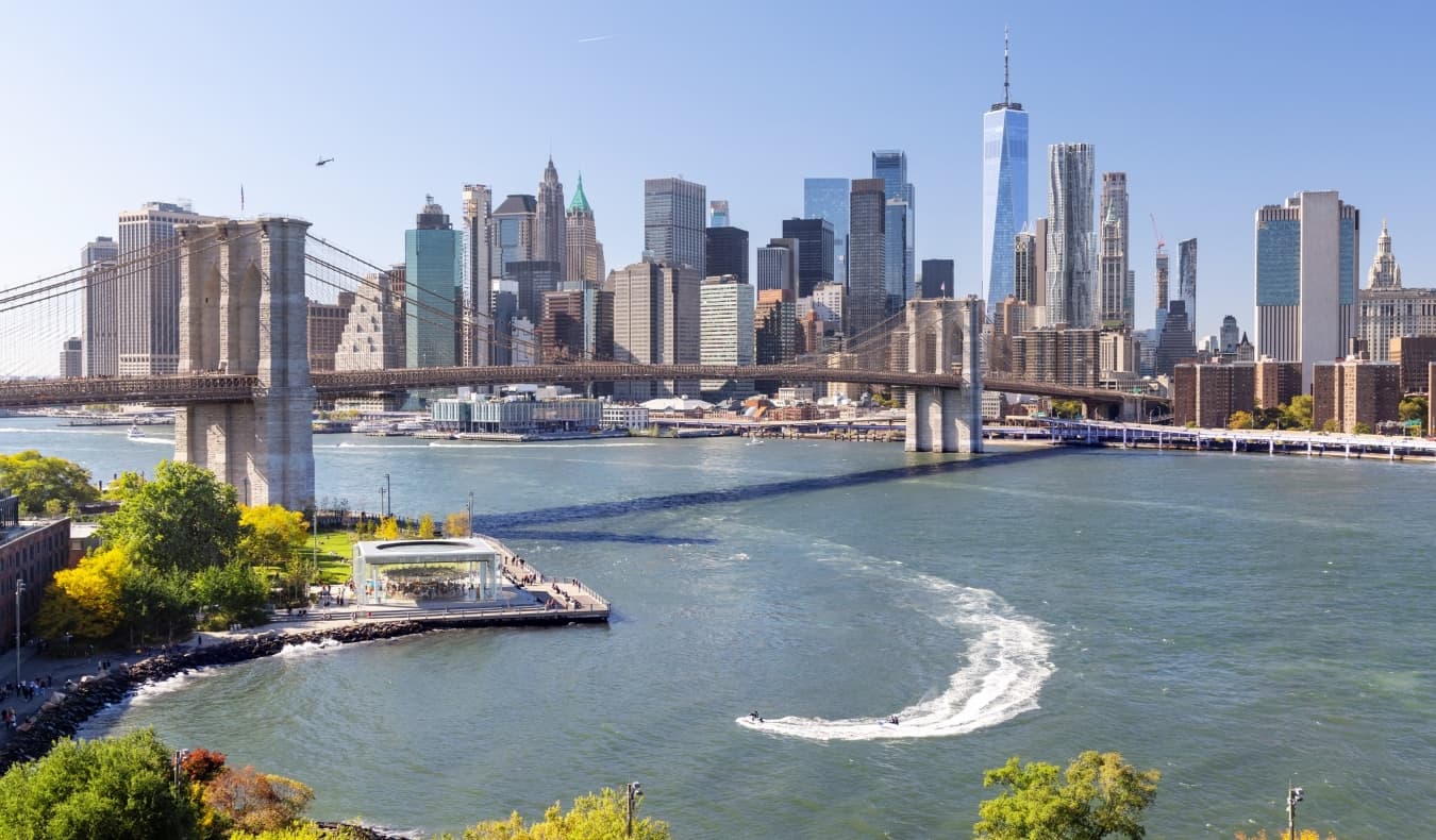 Panoramic New York City skyline with the Brooklyn bridge in the foreground